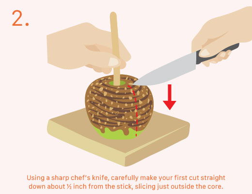 Hands cutting a food item on a wooden board with a knife.