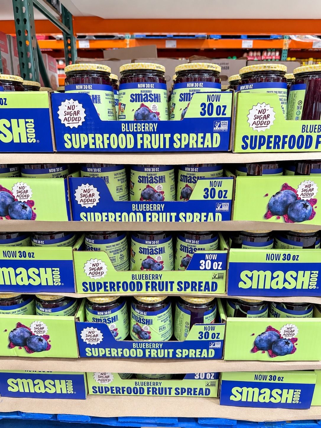 Jars of blueberry superfood fruit spread stacked on shelves.