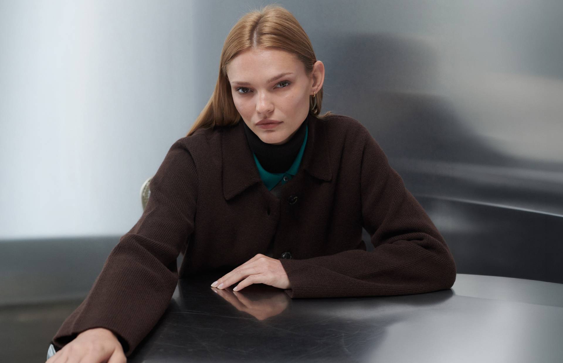 woman sitting at table with arm out