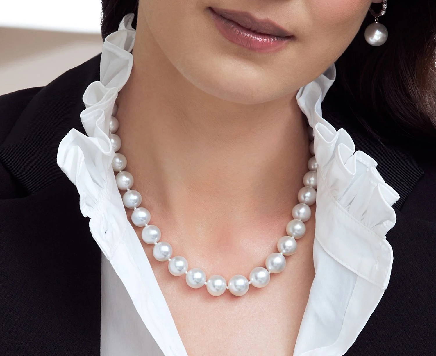 Model with dark hair wearing a South Sea pearl necklace