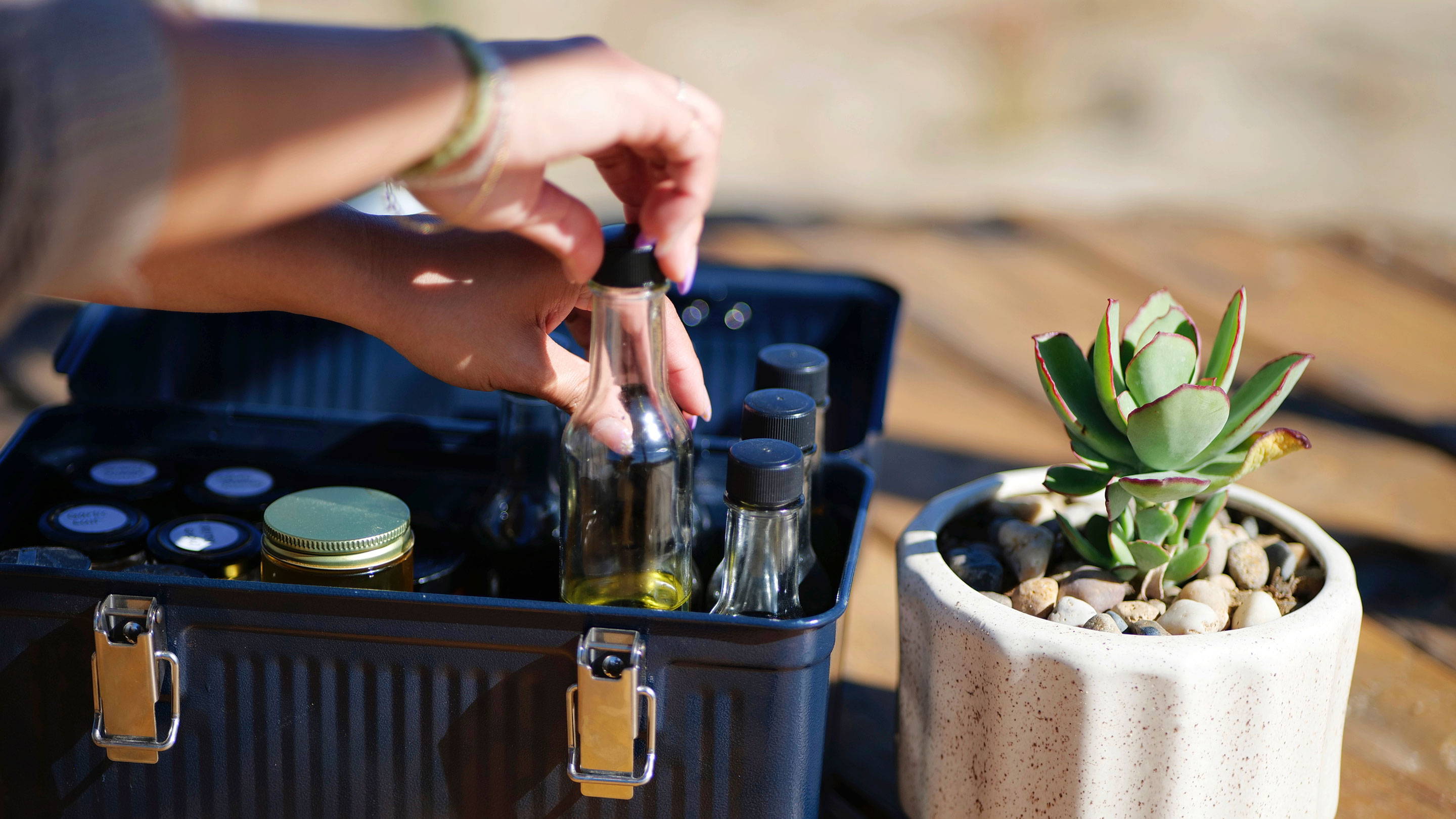 Chef Stephanie Tea places a small bottle of cooking oil inside Stanley’s stainless-steel Classic Lunch Box.