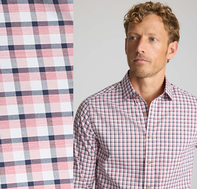 Man wearing a checkered shirt with a fabric swatch beside him.