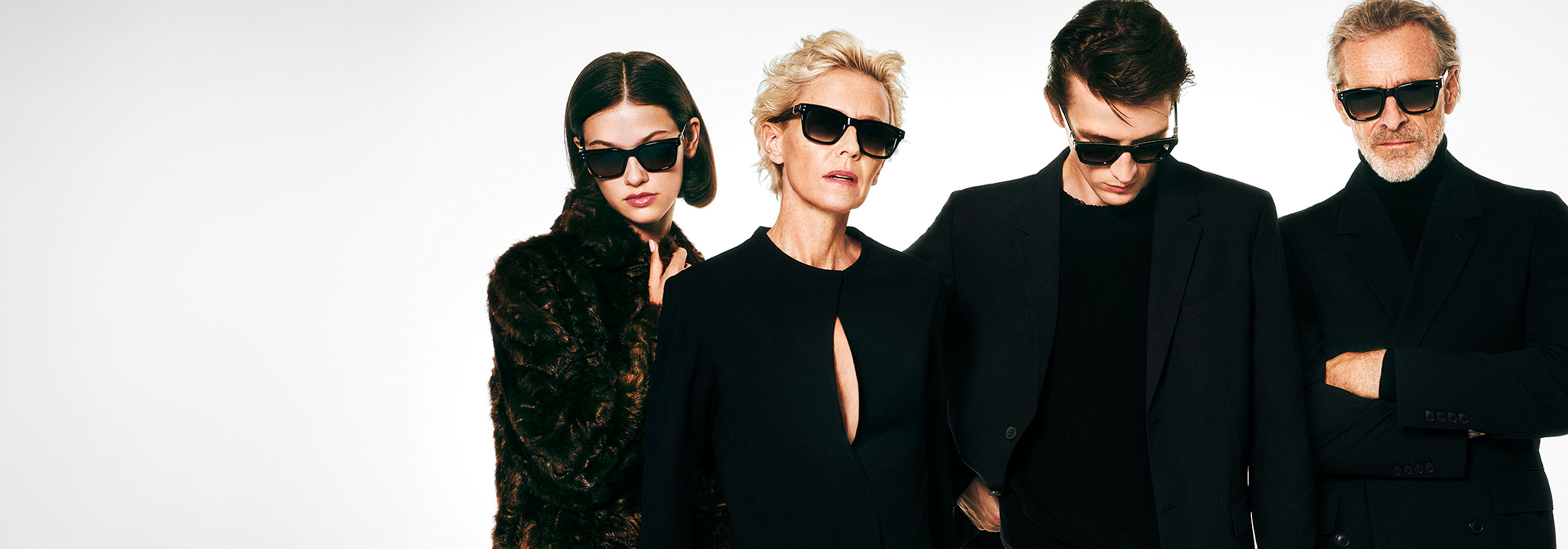 Four people wearing Robert Marc sunglasses, dressed in black, posing together.