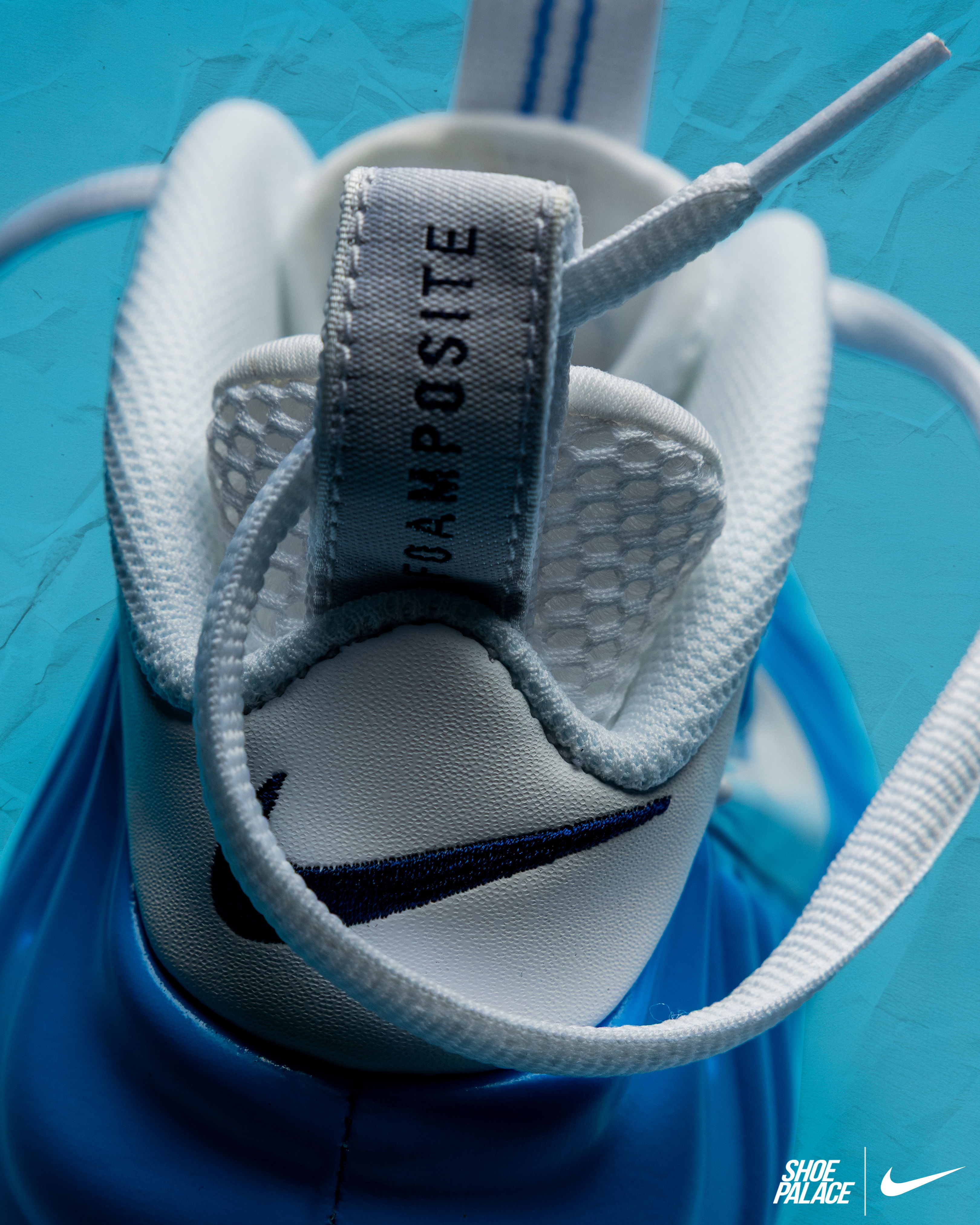 Close-up of a blue Nike shoe with laces and label.