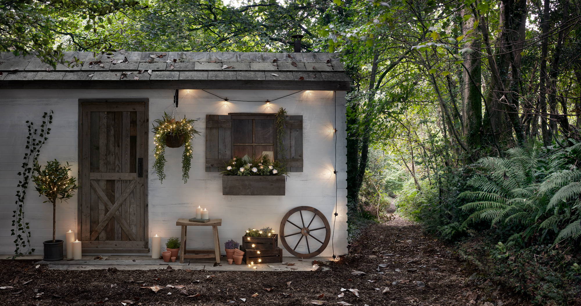 Woodland cabin with festoon lights, LED candles and fairy lights displayed