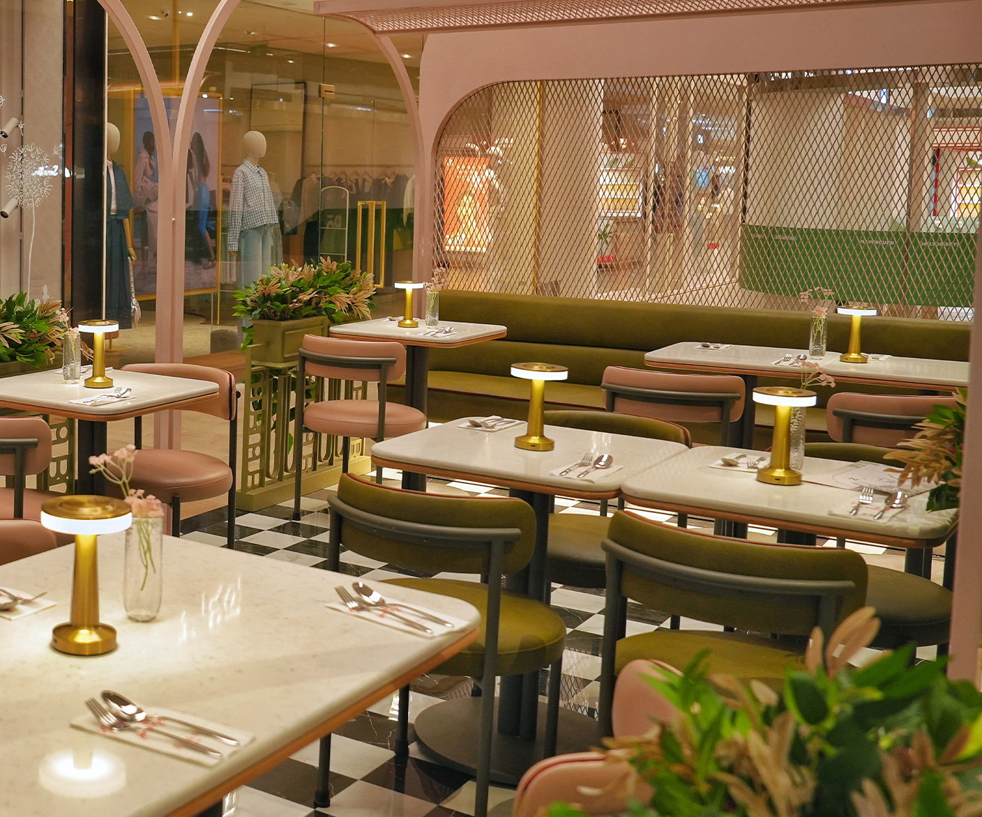 Interior of a stylish restaurant with tables, chairs, and decorative lighting.