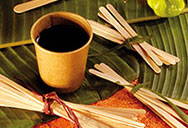 A coffee cup with stirrers scattered around