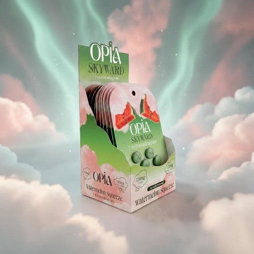 Green packaging of Opia snacks with clouds and colorful background.