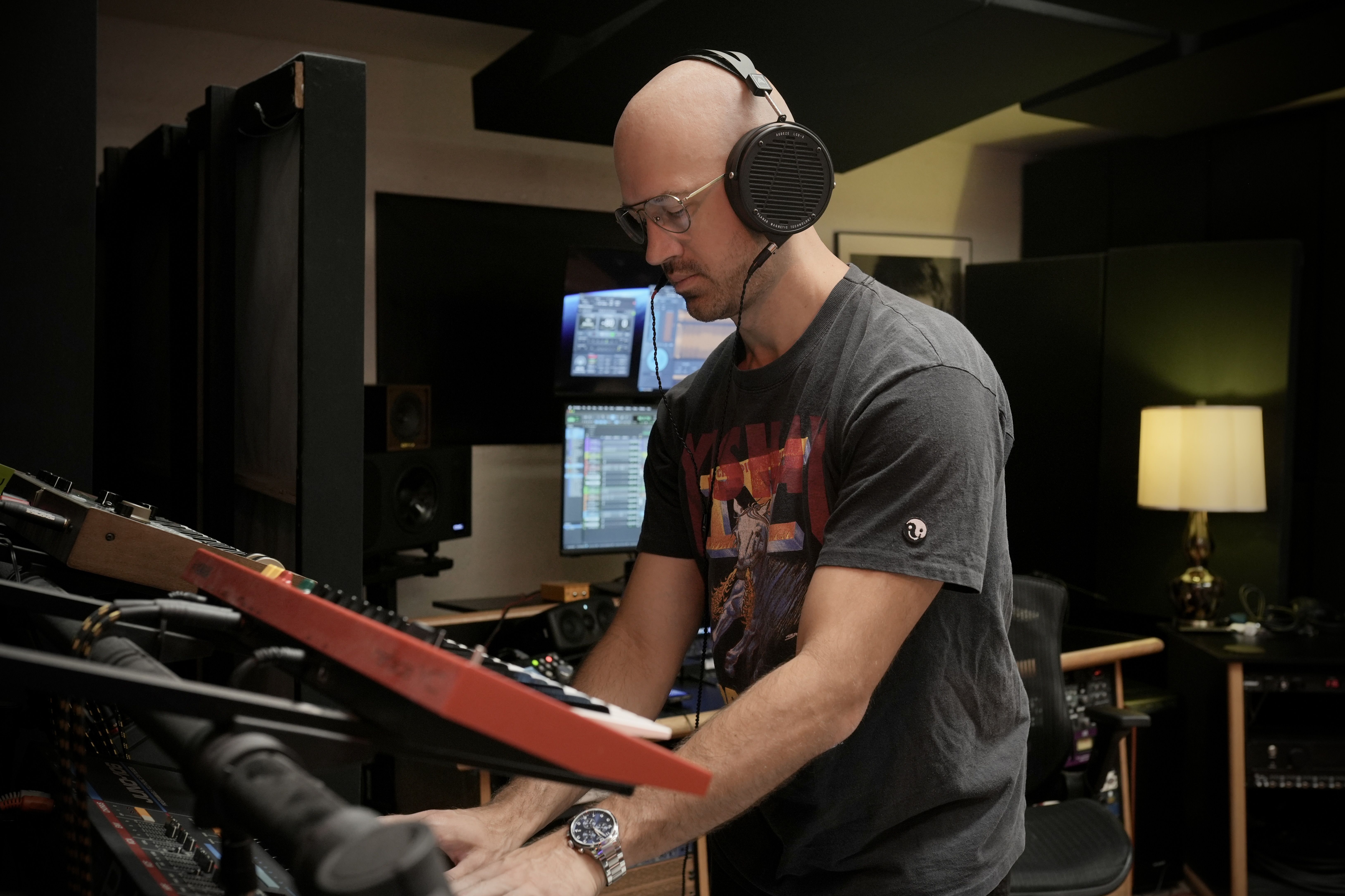 Steve Dressor wearing Audeze LCD-X headphones mixing in the studio