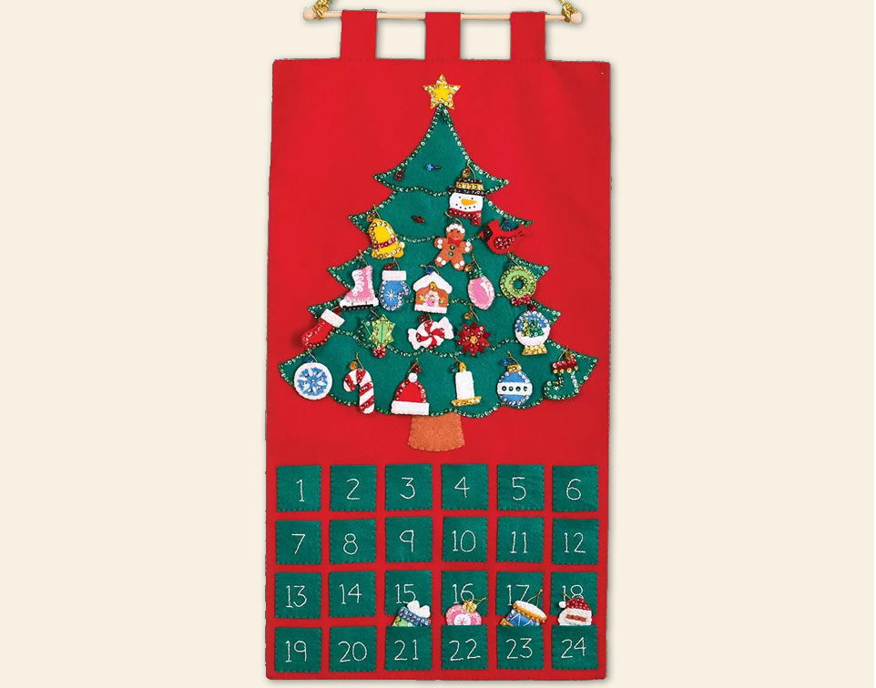 Fabric advent calendar shaped like a Christmas tree with decorations.