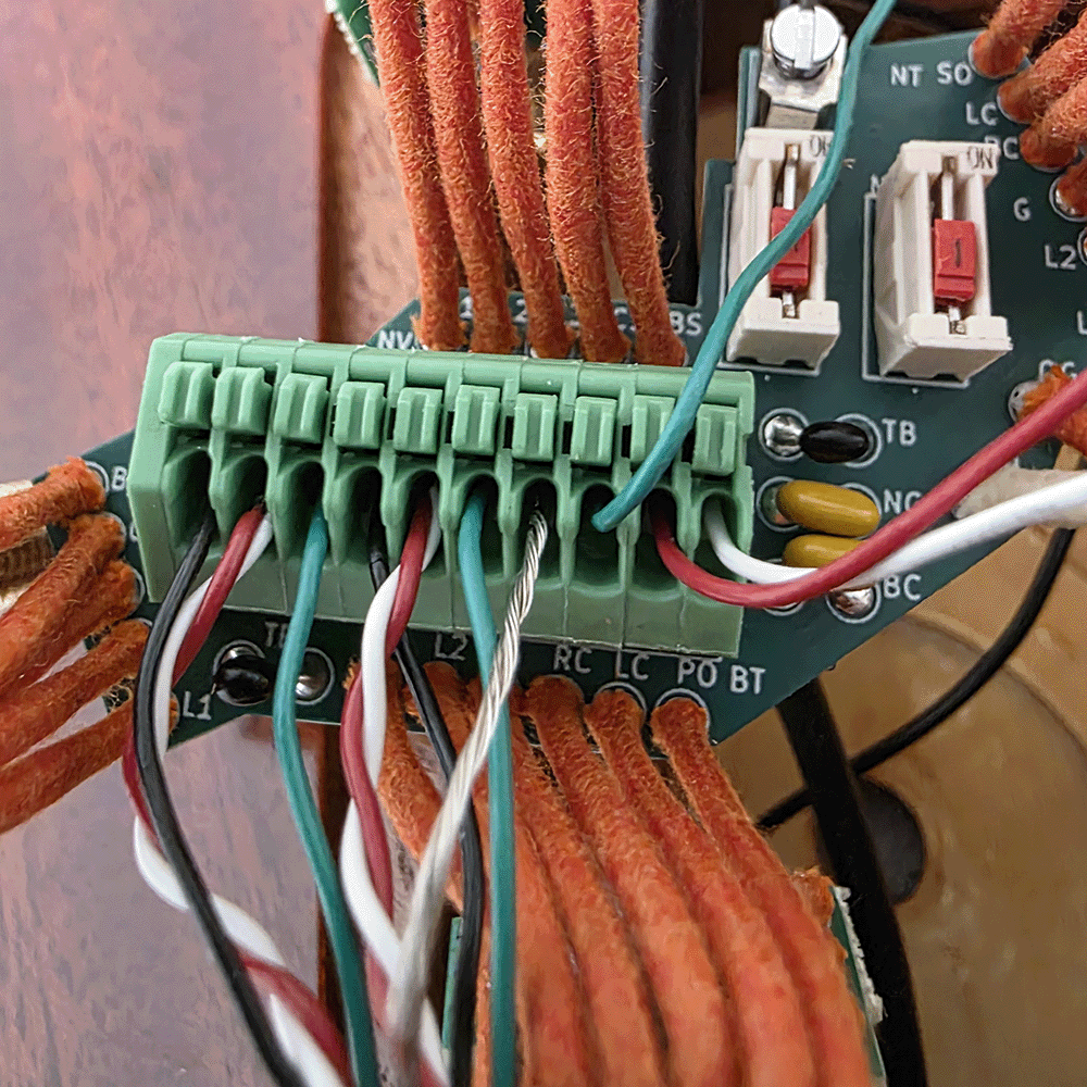 Close-up of a circuit board with multiple wire connections.