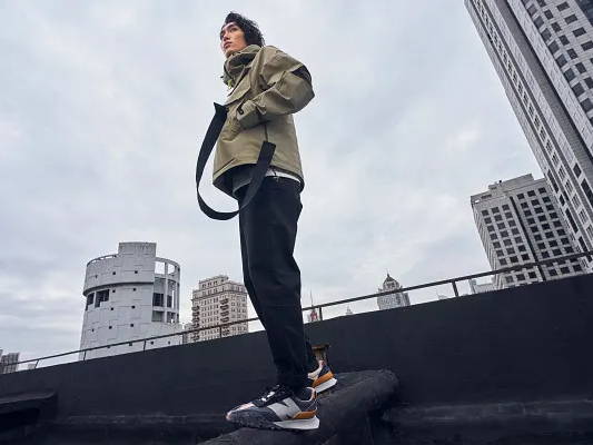 male model wearing new balance chinese new year footwear and apparel on rooftop