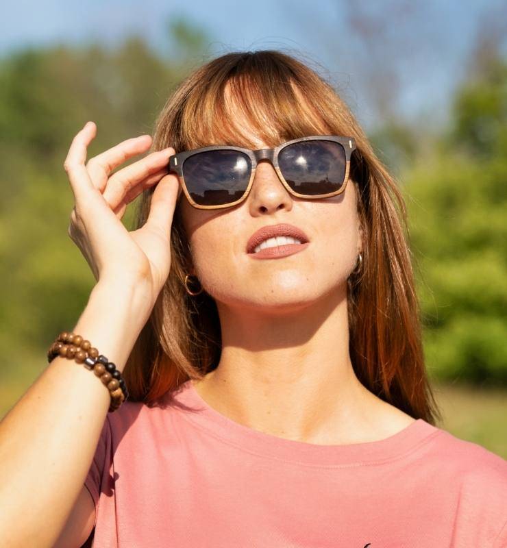 Woman wearing Oxford two tone sunglasses made from ebony and teak wood