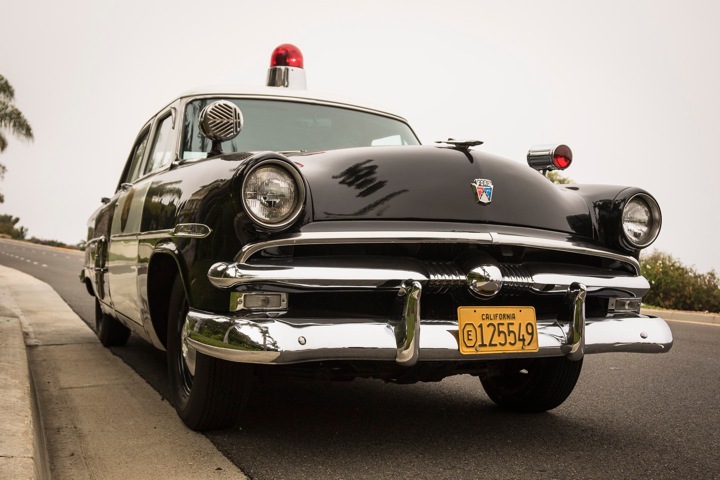 Classic police car with a vintage design and roof lights.