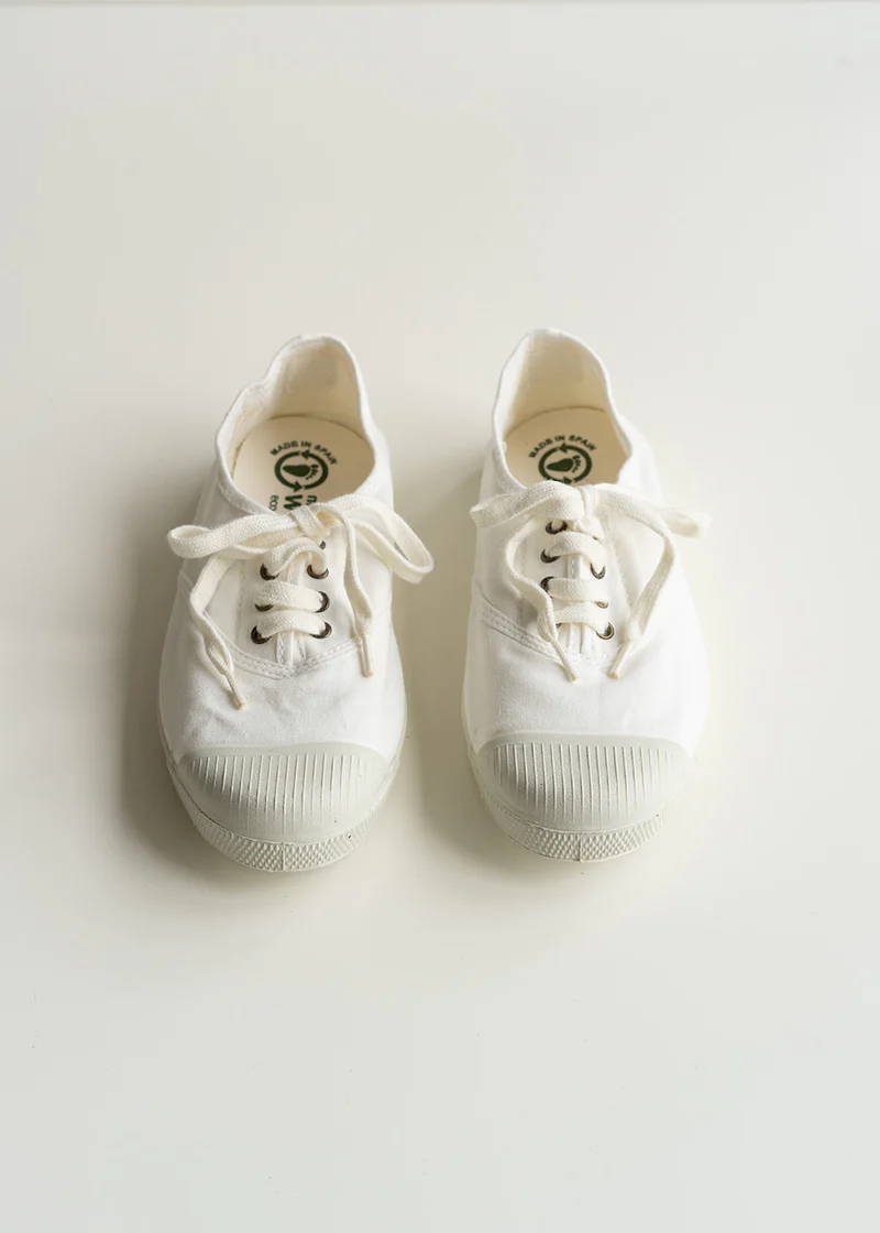 A pair of white cotton pump trainers