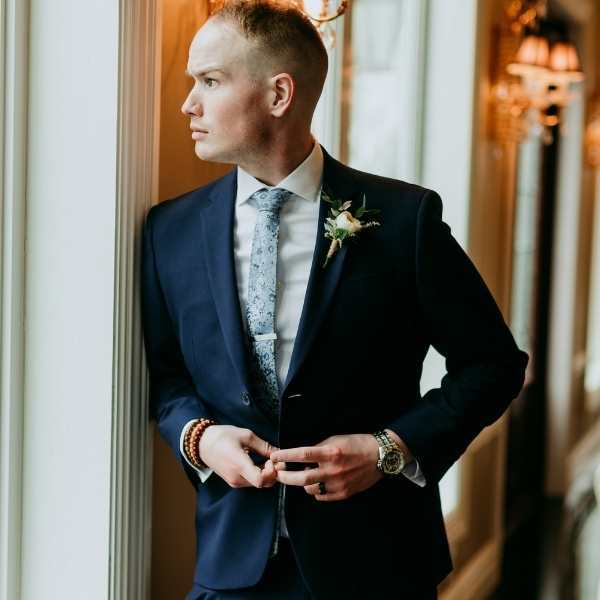 Groom wearing a blue floral tie