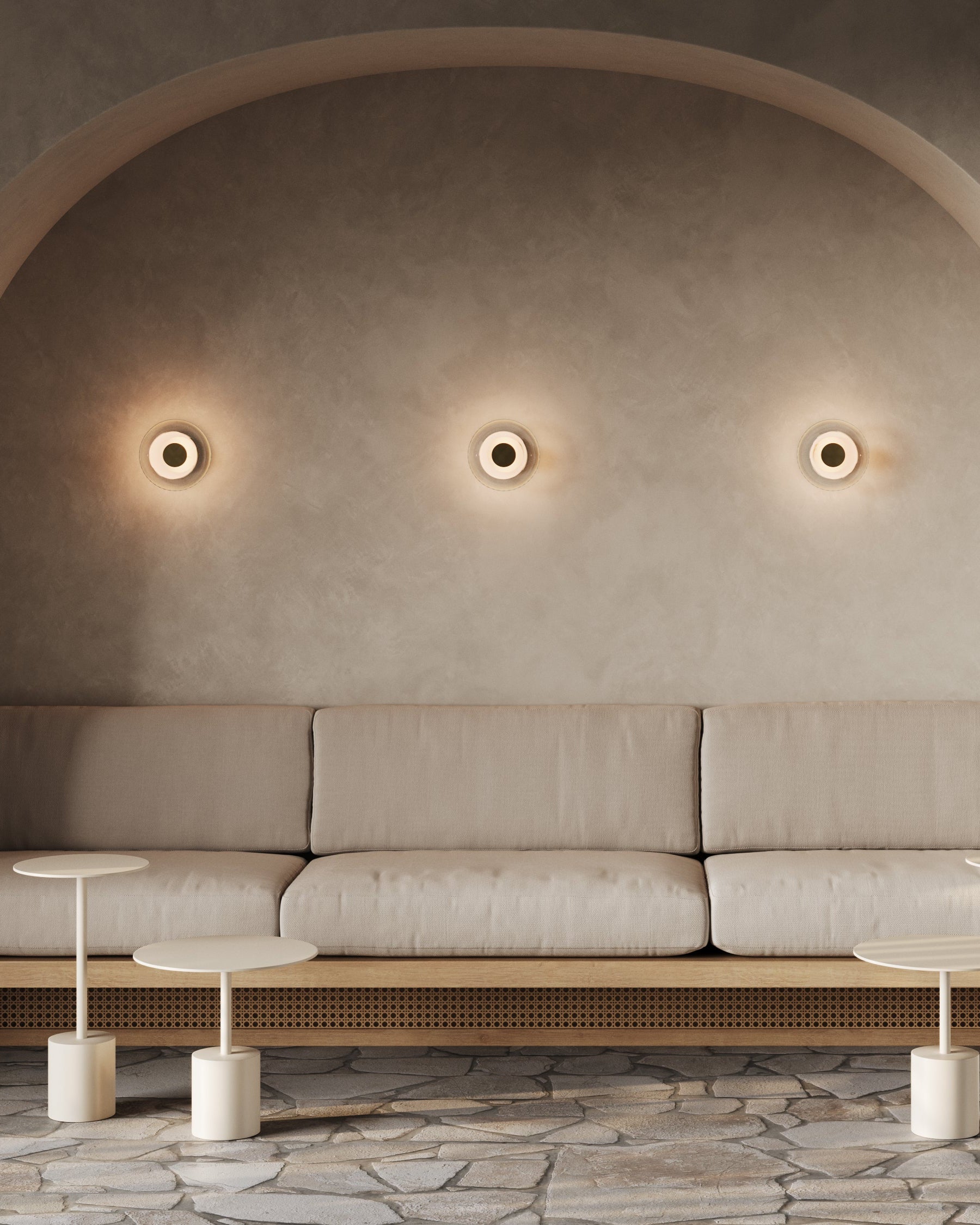 Modern living room with a beige sofa, side tables, and wall lights.