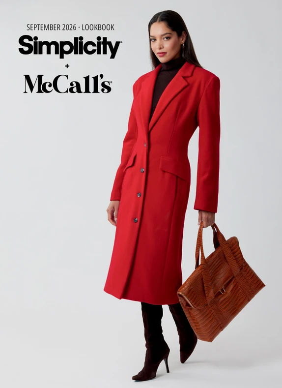 Model in a red coat holding a brown bag, styled for a lookbook.