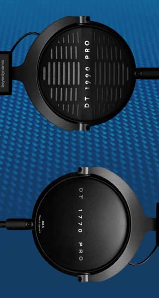 Two pairs of headphones on a blue background. One pair are open back, the other are closed back.