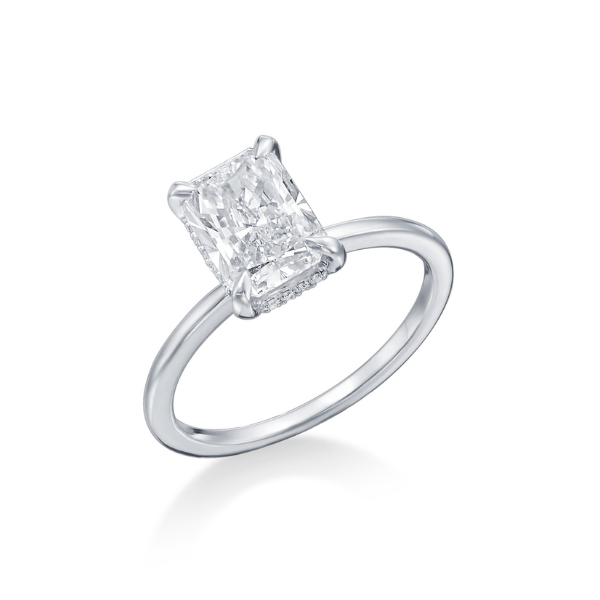 A solitaire diamond ring with a rectangular cut stone on a simple band.