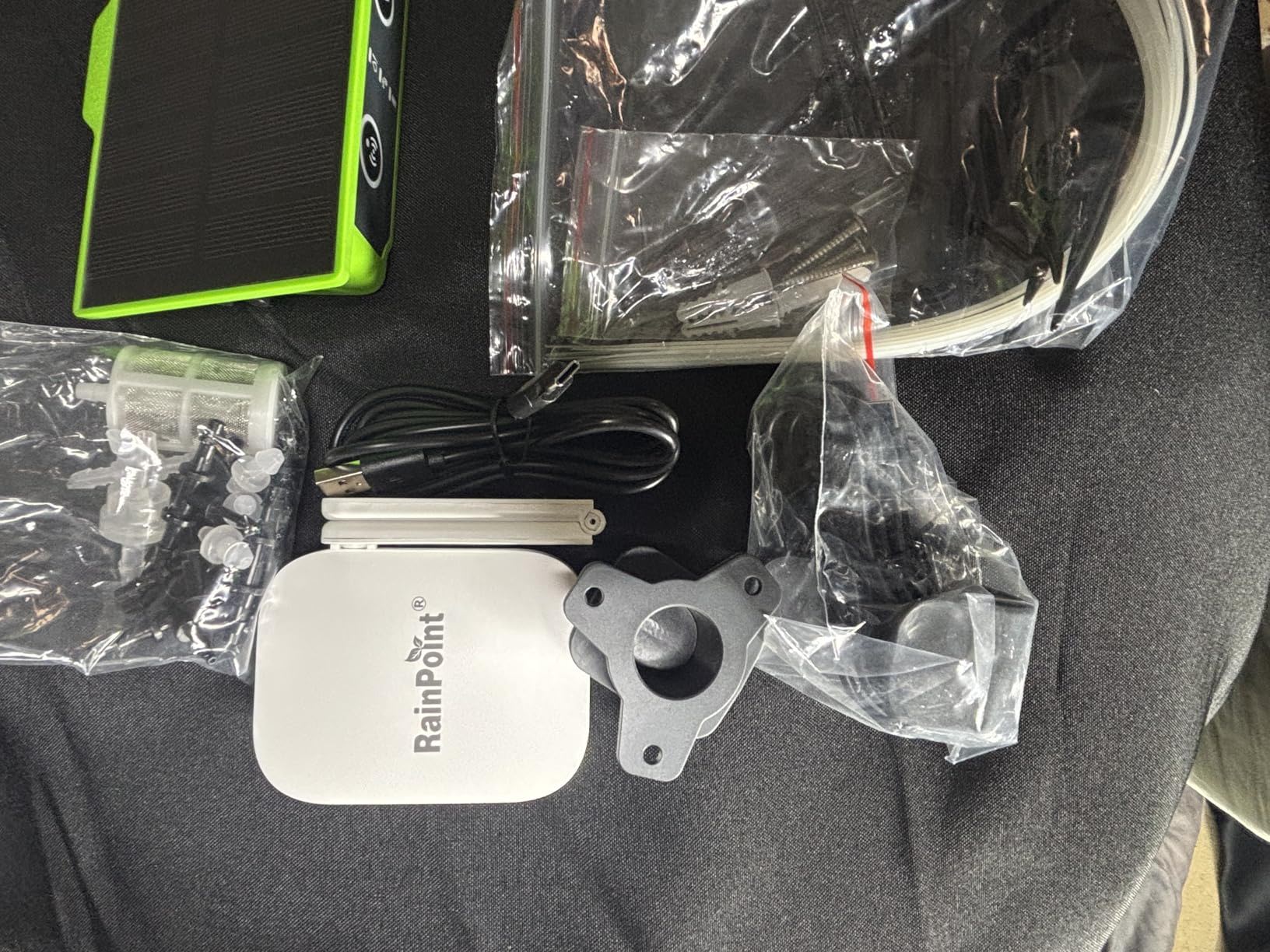 Various electronic items including cables, a device, and packaging.
