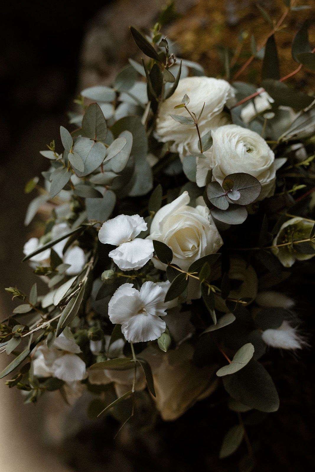 A bouquet of white roses and greenery.
