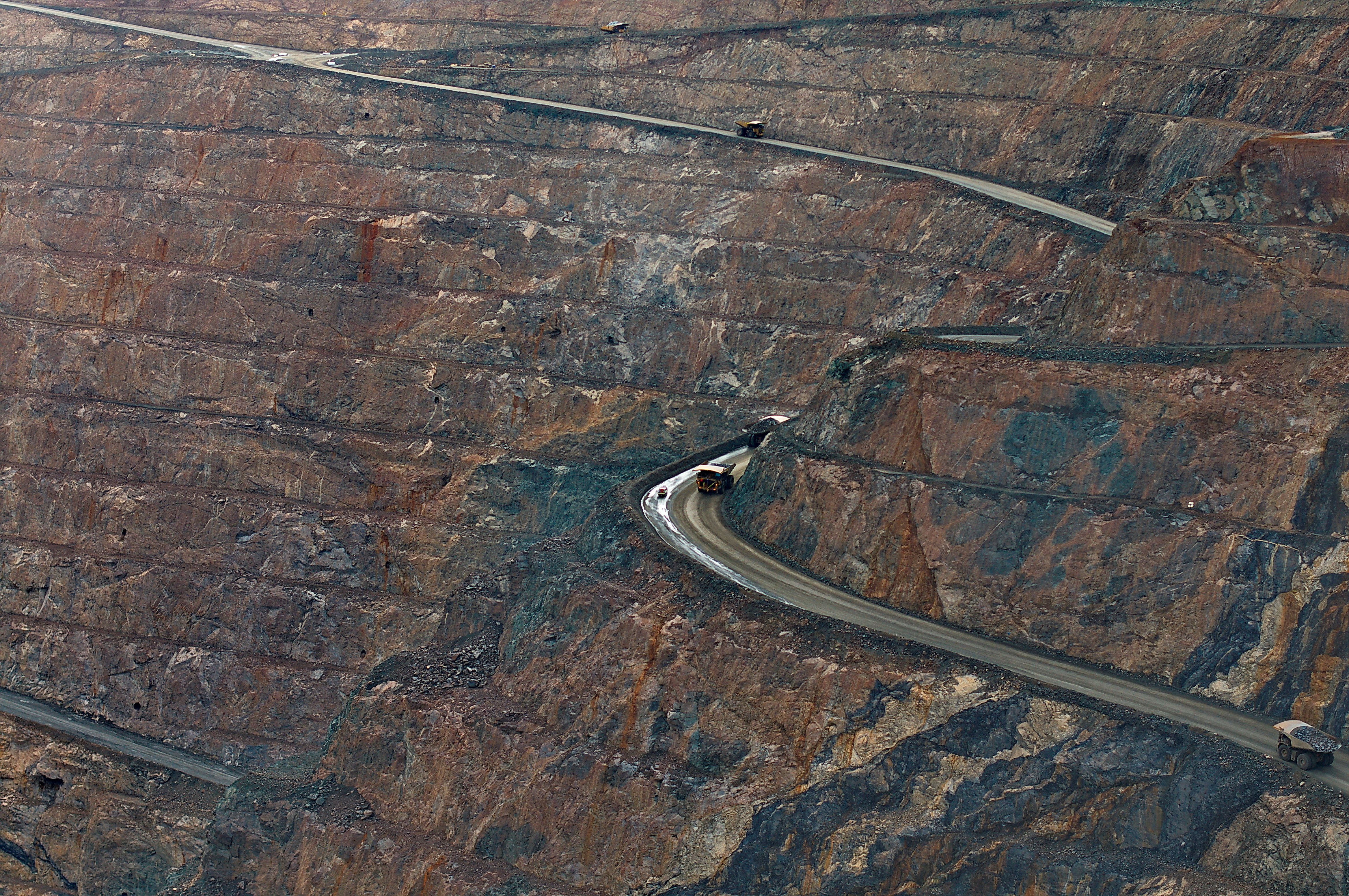 DJI Matrice 4E surveying an open-pit mine high wall and benches