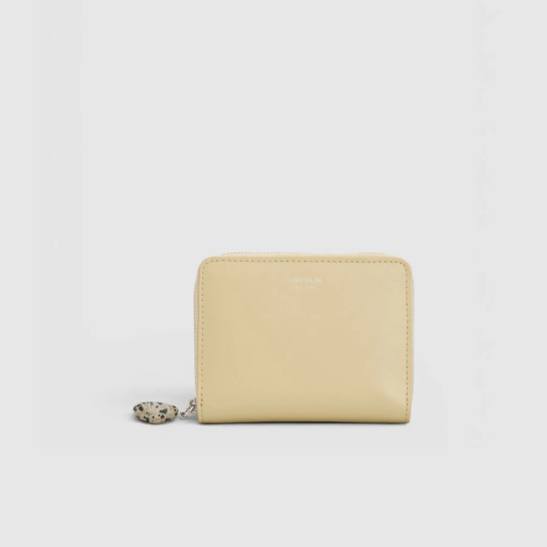 A light yellow wallet with a zipper and keychain attachment.