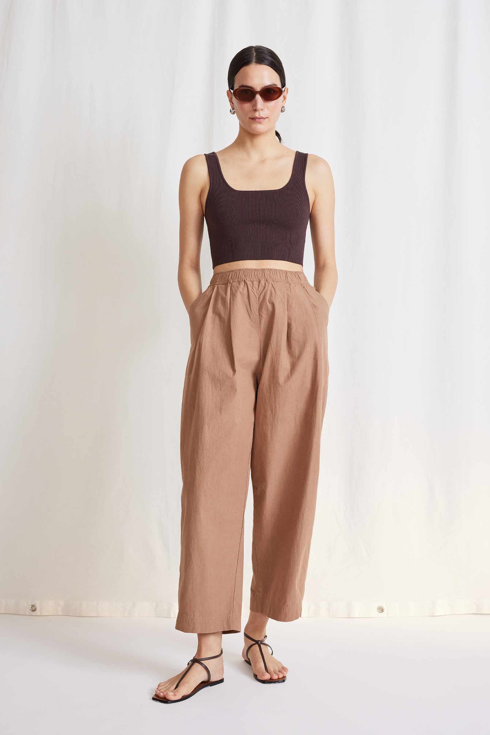 A lookbook image of a model wearing the Apiece Apart Spa Pleat Pant.