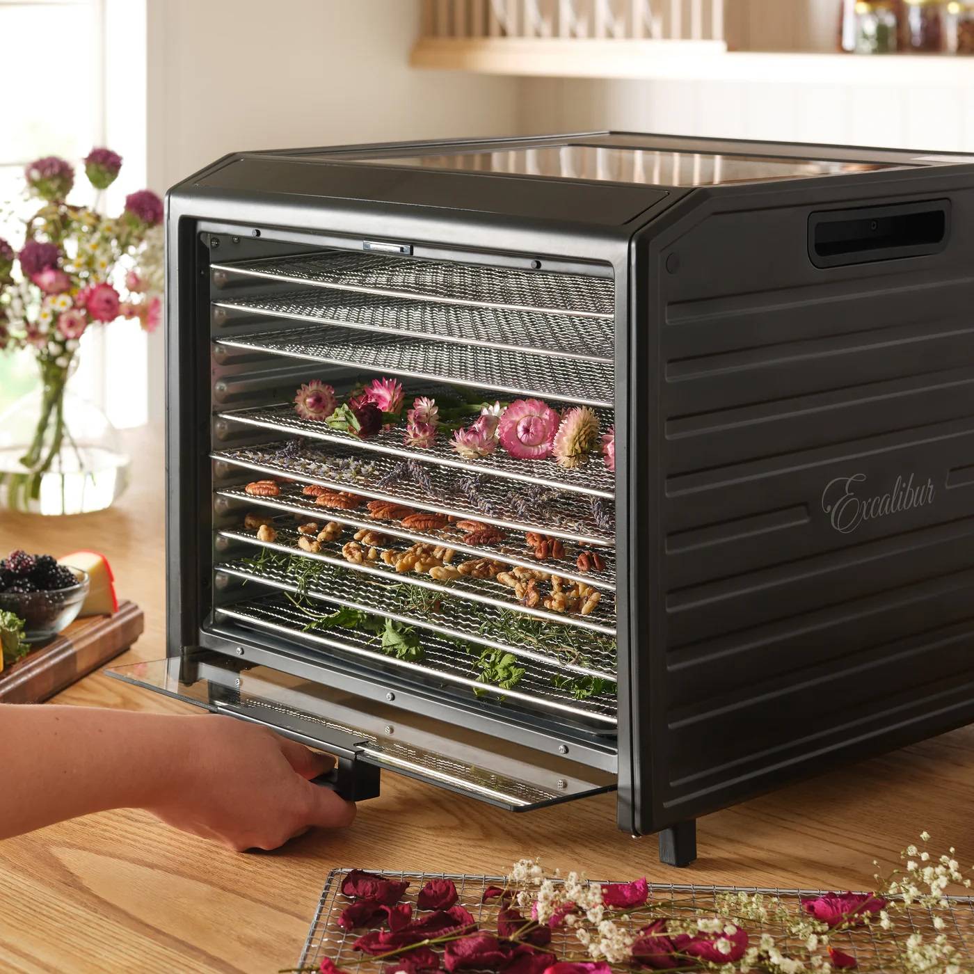 Excalibur DH10SS performance digital 10 tray stainless steel dehydrator with flowers on trays.