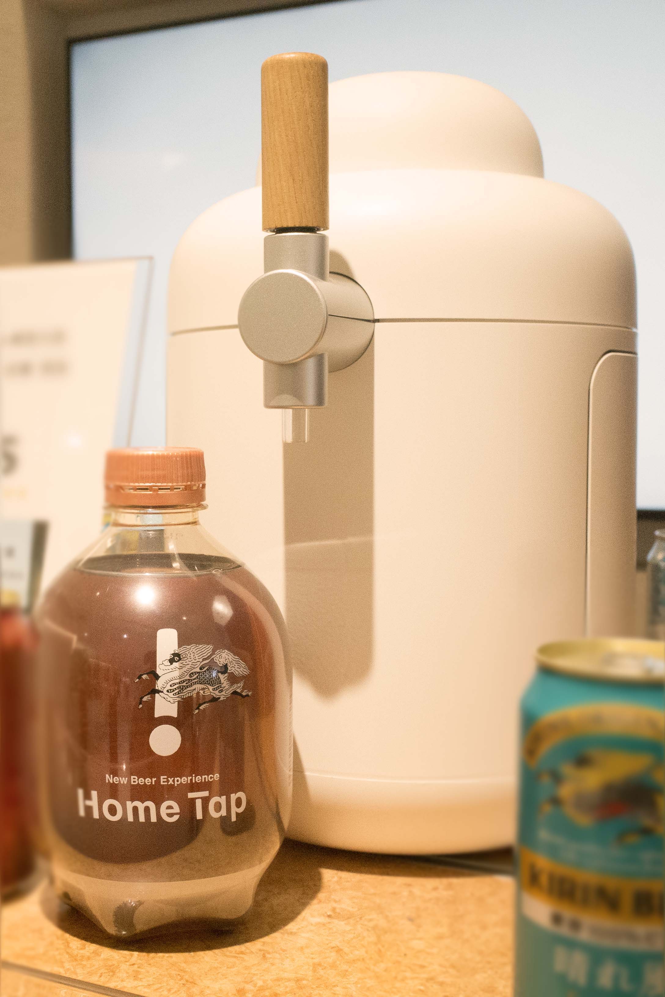 A white beverage dispenser next to a bottle labeled 