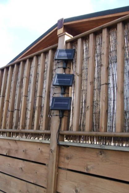 Solar pannels on the side of some decking.
