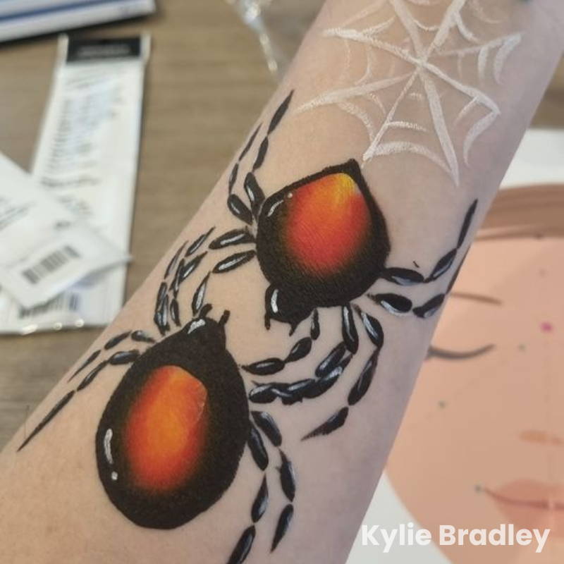 spider face paint on arm with spiderweb