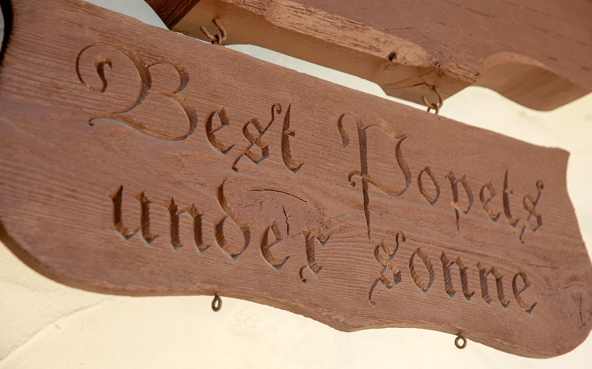 A hand carved wood sign that reads 