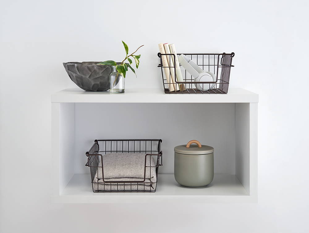 Dark bronze wire baskets on a shelf with items inside