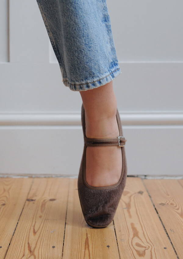 A styled image of a model foot on point wearing the Drogheria Crivellini Pony Maary Jane in brown.