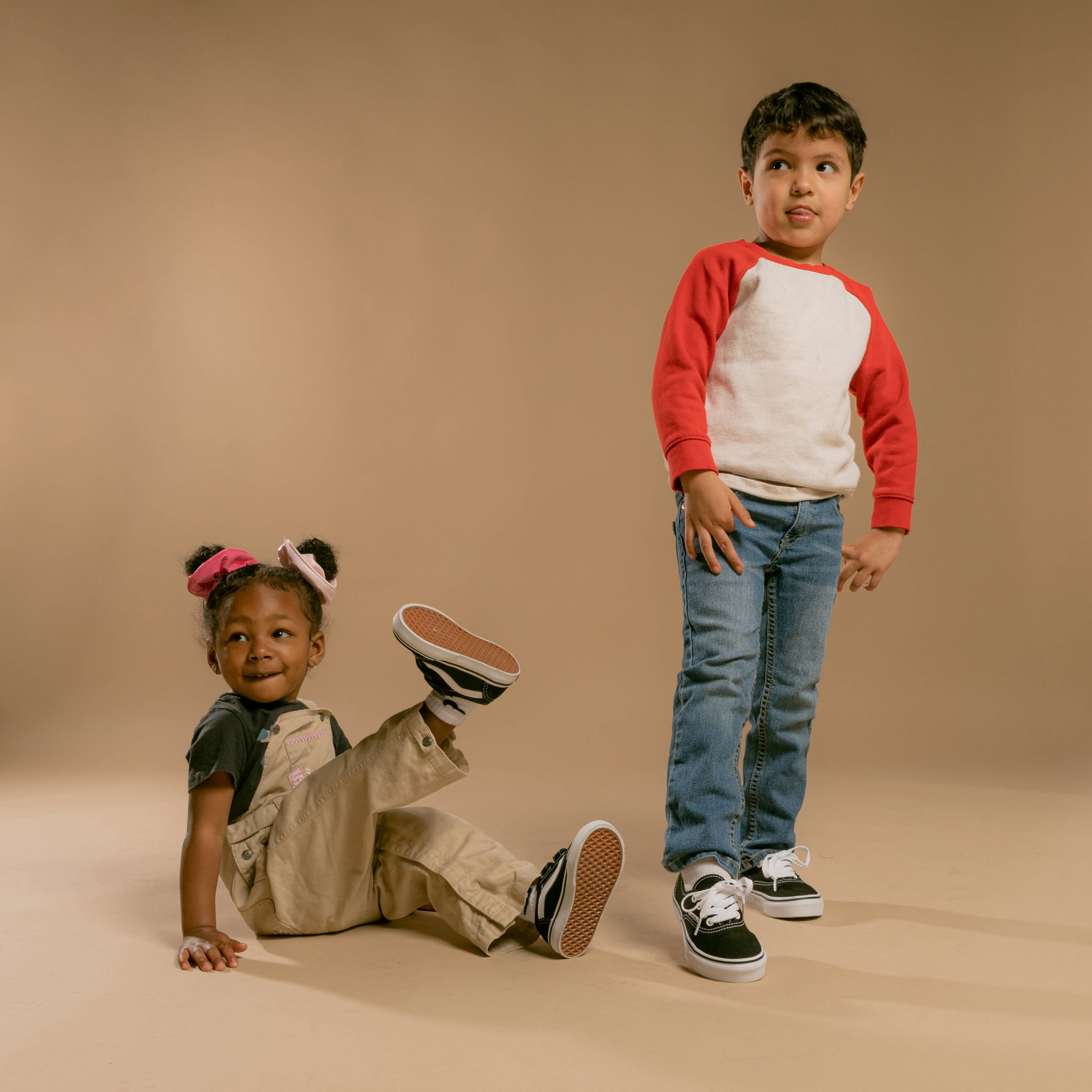 young girl and boy wearing black vans