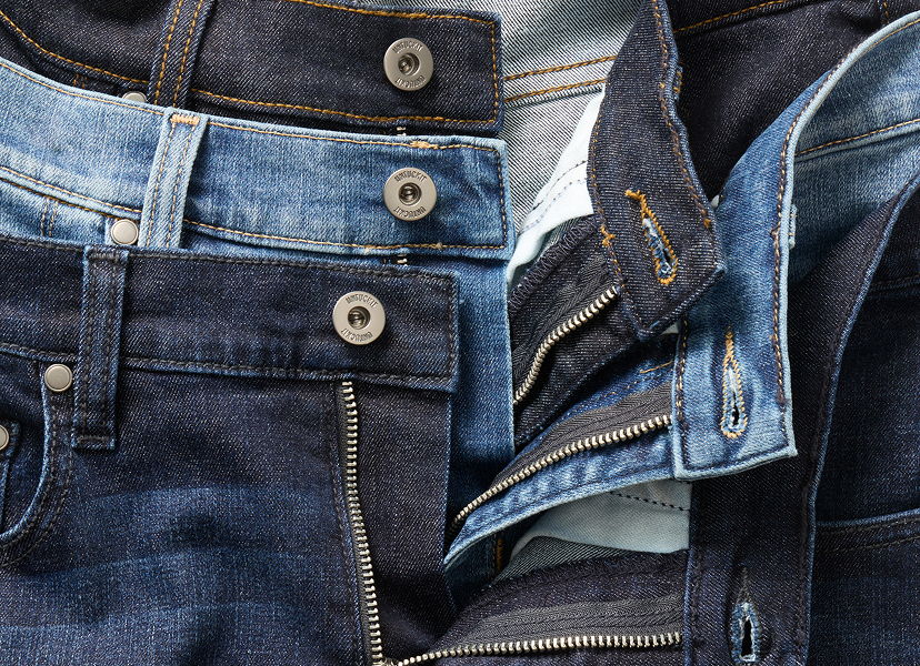 Various styles of denim jeans in different shades of blue.