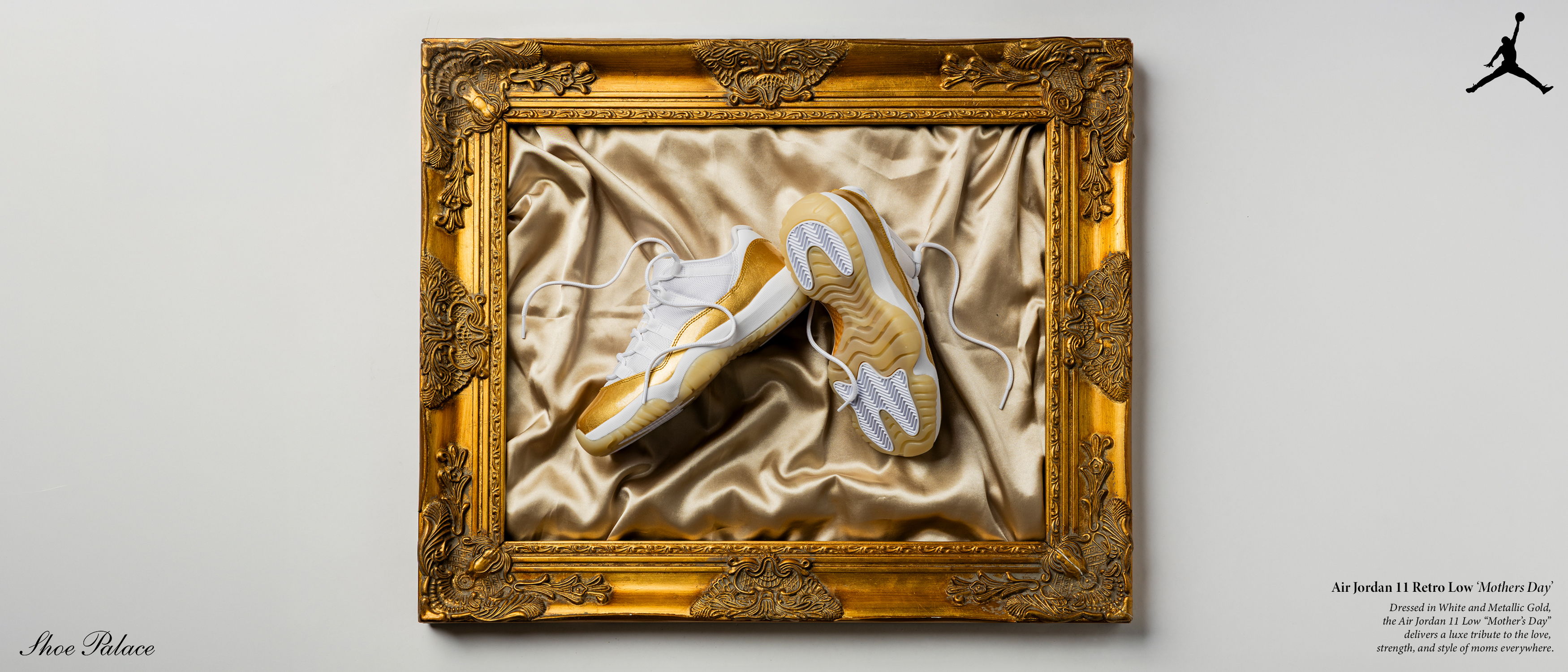 A pair of elegant shoes displayed in a golden ornate frame.