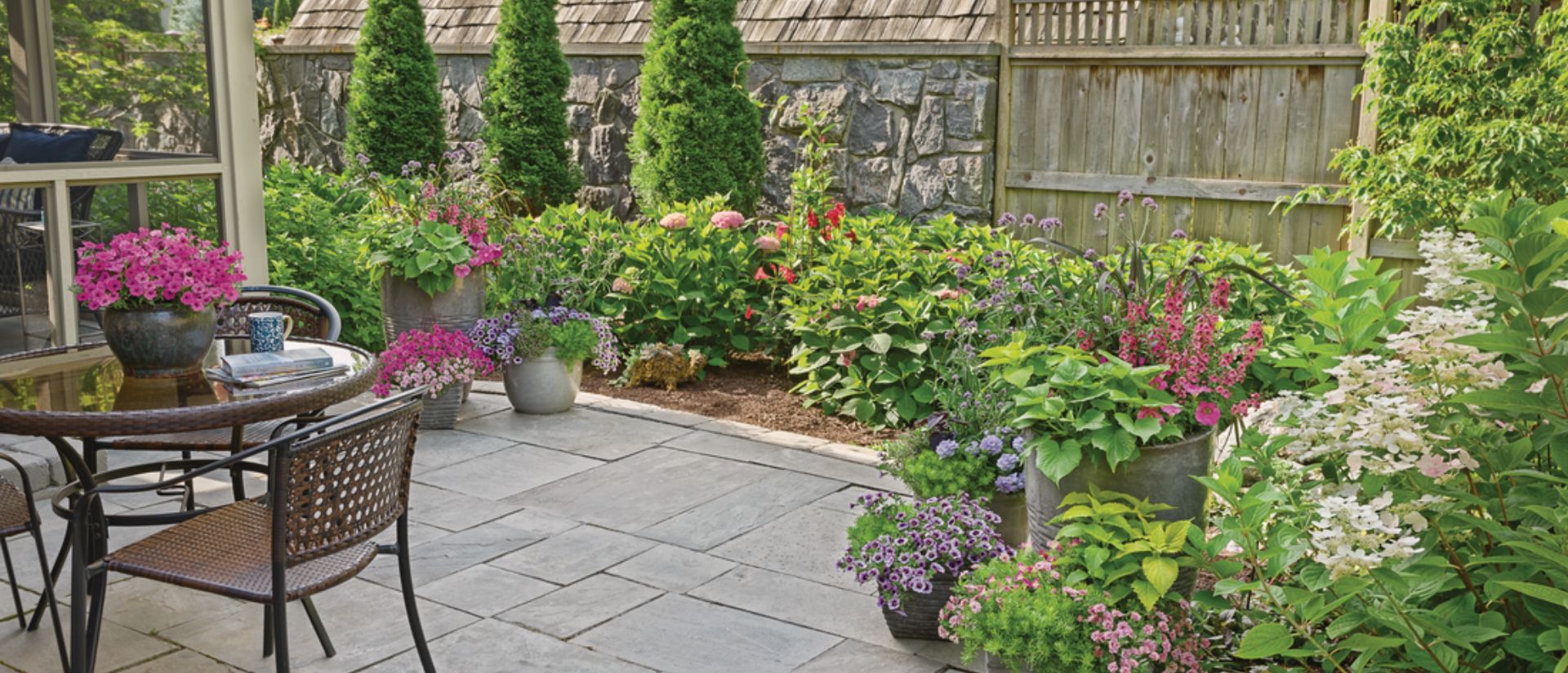 Small patio Supertunia Mini Vista® Hot Pink and other perennials and shrubs