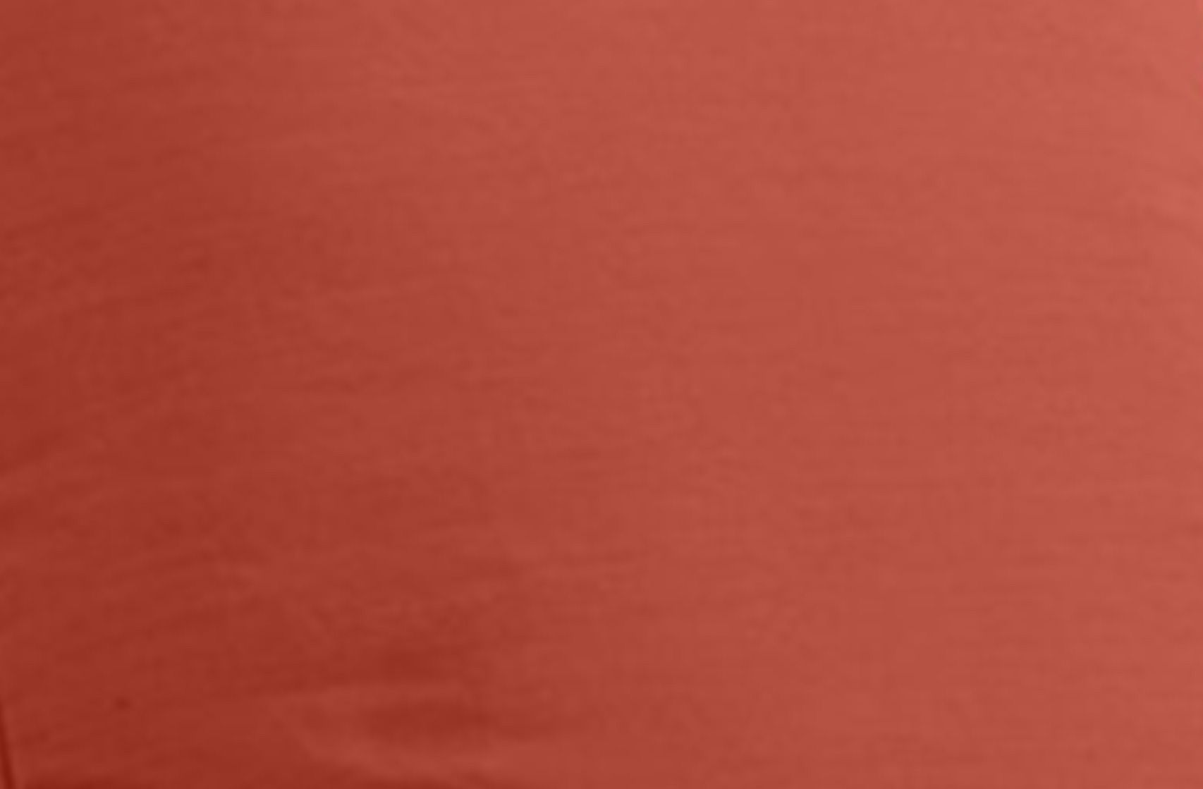 Solid red fabric texture with subtle sheen.