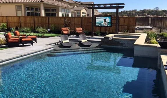 Outdoor TV enclosure by a pool