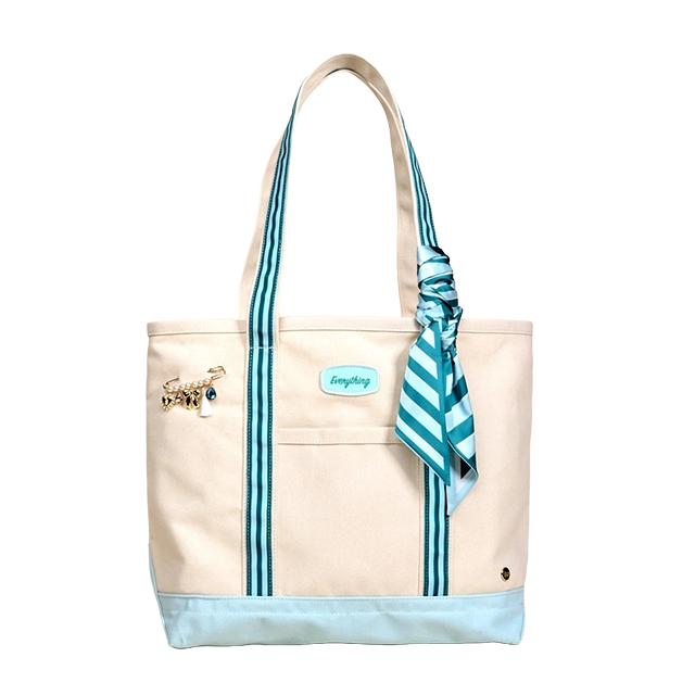 A stylish tote bag with striped handles and a decorative scarf.