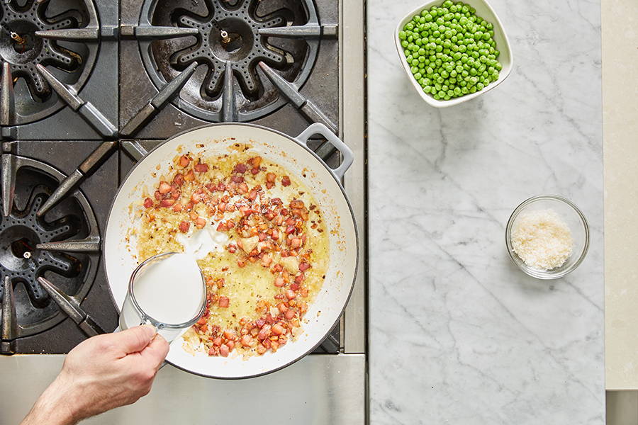 Adding cream to the pan