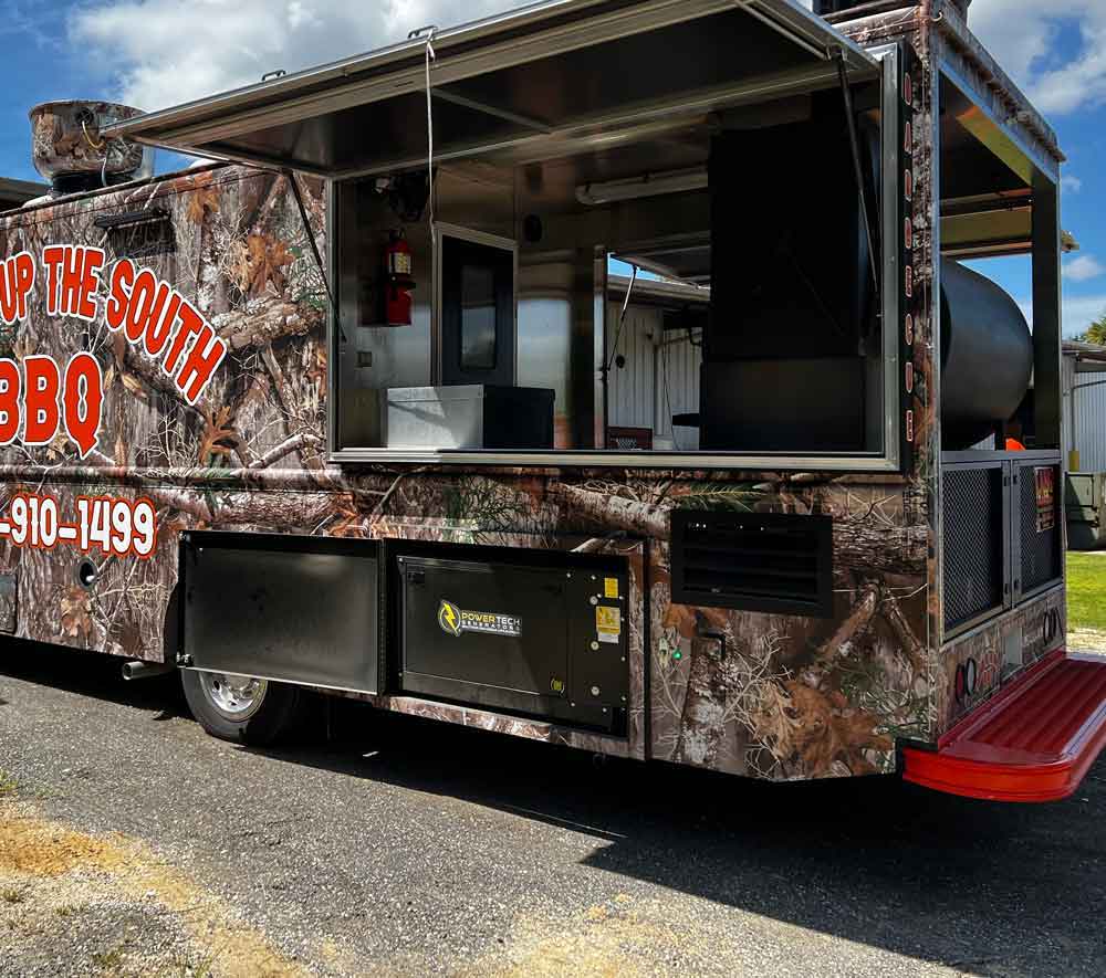 Enclosed generator installed in a food truck.