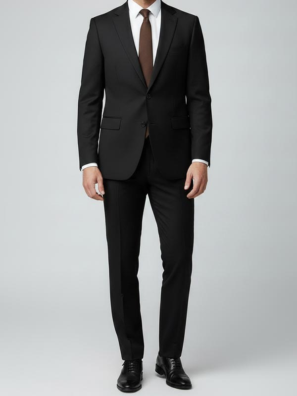 Man wearing a black suit with a brown tie