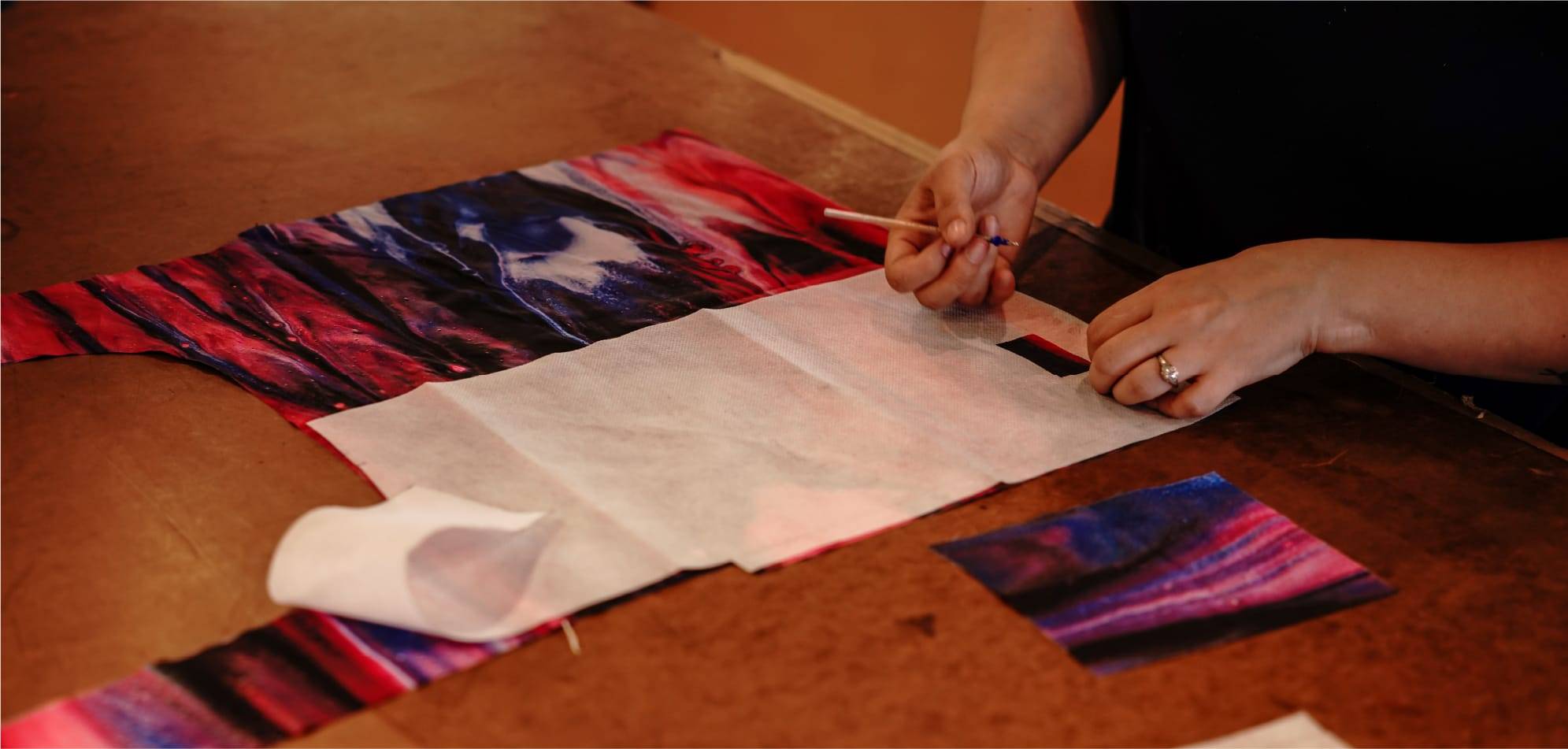 Woman cutting out the pattern of a reusable tote