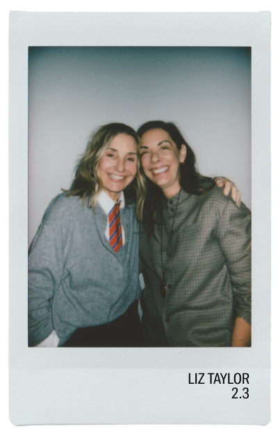 Two smiling women posing for a photo together, wearing casual outfits.
