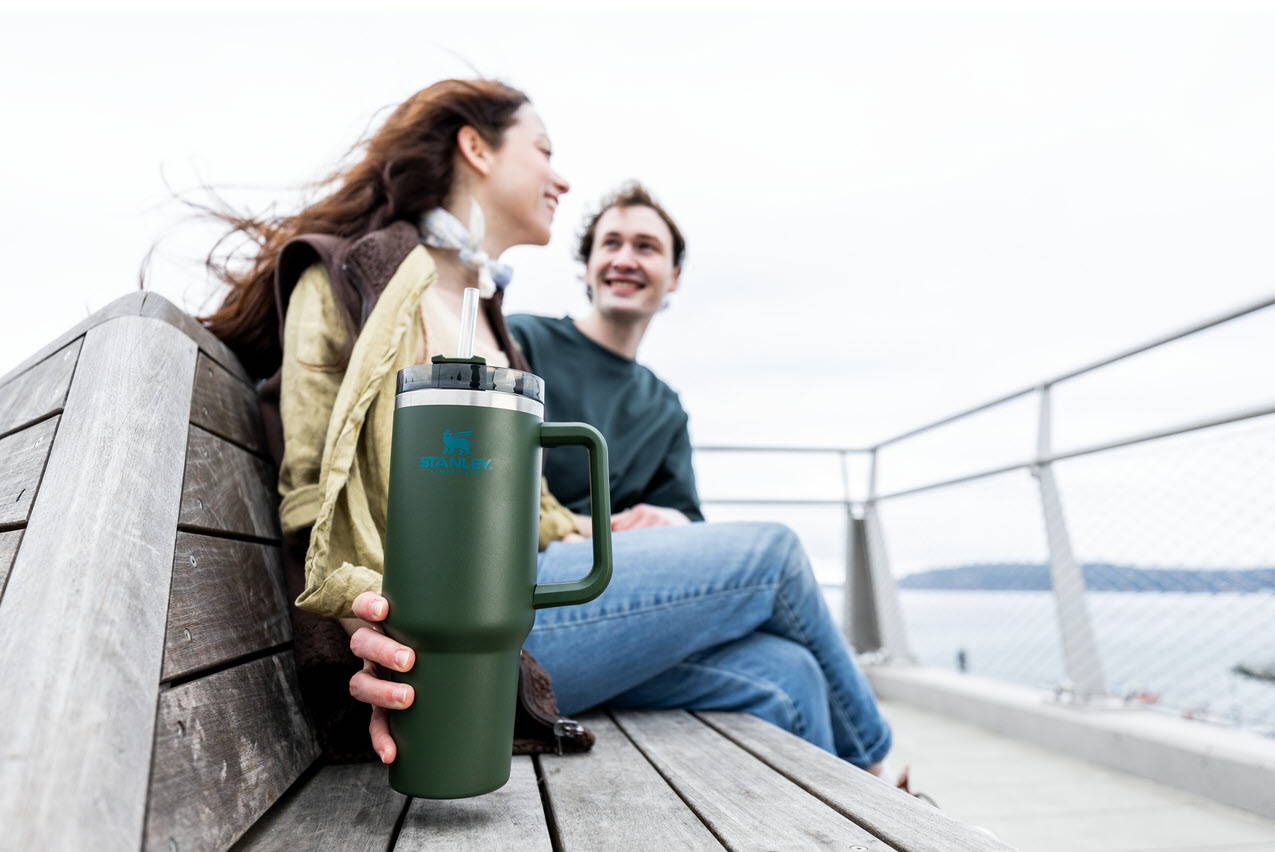 A Couple At The Pier With A Stanley QuencherTumbler