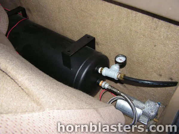 Close-up air tank with pressure gauge and compressor behind seat in Winston's Silverado photo 5